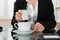 Close-up Of Businesswoman Putting Sugar In Cup