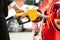 Close-up Of Businesswoman`s Hand Refueling Car`s Tank