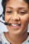 Close Up Of Businesswoman Wearing Telephone Headset In Customer Services Department