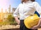 Close up businesswoman with yellow safety helmet in industry scene