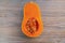 Close up of a butternut squash on a wooden table.