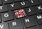 Close up of button with various flags on black keyboard