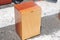 Close-up of a cajon, man\\\'s legs and hands are shown as he\\\'s playing the instrument
