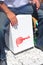 Close-up of a cajon, man\'s legs and hands are shown as he\'s playing the instrument