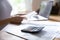 Close up calculating machine and financial paperwork on table