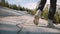 Close-up camera follows male legs in white desert shoes running and stopping on epic Yosemite forest rock slow motion.