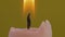 Close-up of candle wick ignited with match isolated on yellow background
