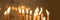 Close up of candles in a church panoramic christmas and holiday lights background