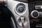 Close-up car engine ignition start and stop button on the dashboard, electric key, modern gray design with chrome elements on the