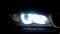 Close up of car headlight turning on