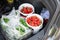 Close-up car trunk with fresh ripe organic vegetables and berries bought  on farmers market. Red juicy sweet strawberries ,