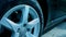 Close-up of car wheel with shiny silver rim. Slowmotion presentation of car details