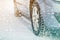 Close-up of car wheels rubber tires in deep winter snow. Transportation and safety concept