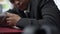 Close-up of careless exhausted African American man sleeping on laptop putting pillow under head. Tired overworked young