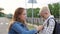 Close-up of a caring mother button up her son`s jacket before school.