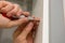 Close up of carpenter hands marks the furniture with a kerner