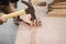 Close up of a Carpenter hitting a nail into a wooden board using a metal hammer.