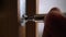Close up of carpenter repairing door lock. Installing a door handle. Handyman tightening door hinge . Hands of the repairman with