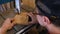 Close-up of a carpenter\'s hands working on a band saw with a wooden mold to create interior items