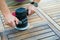 Close-up of carpenter`s hands working with electric sander