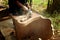 Close up of a carpenter scrubbing wood chair with handheld electric scrubber