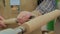 Close up: carpenter using gouge for shaping piece of wood on lathe, slow motion