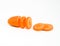 Close up carrot sliced into pieces with reflecting orange shadow on white background