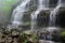 close-up of cascading spring waterfalls, with droplets of water and mist visible