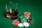 Close up of casino chips and whisky glass on table