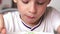 Close-up Caucasian Boy 5-7 Years Eating Breakfast Chocolate Pillows Milk Easy Breakfast Selective focus, shallow depth of field