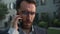 Close-up Caucasian businessman upset man male entrepreneur employer talking telephone outside unpleasant business