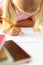 Close-up of caucasian elementary girl writing on book at desk in classroom