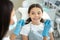 Close up of caucasian girl at dental procedure, dentist using dental instruments in dental office