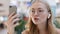 Close-up caucasian girl talking video call young millennial woman using phone and wireless headphones have fun