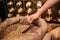 Close up of caucasian hand holding food scoop with raw coffee. Golden beans. Cut view.