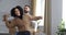 Close-up caucasian man and african american curly-haired woman couple dancing in new house rented apartment near