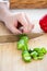 Close-up of a caucasian man cutting a cucumber