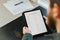 Close up caucasian man getting visa and reading application on tablet, passport on desk.