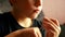 Close-up of a Caucasian preschooler boy cuts his nails on his hand using nail scissors. Child`s nail care. Selective focus, shallo