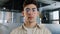 Close-up caucasian serious puzzled clever guy student in glasses looking at camera posing indoors young man with sad