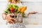 Close up with caucasian woman taking a bucket full of coloured and fresh seasonal vegetables for a healthy and natural food