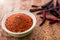 Close up of Cayenne pepper in bowl on wooden background