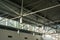 A close-up of a ceiling with lanterns and metal beams in a shopping centre. Inside view of iron structure construction as a