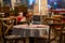 Close up of the centerpiece of a spanish restaurant table with red checkered tablecloth and wood chairs