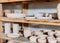 close up of ceramic plates and bowls on wooden shelves