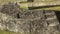 Close up of a ceremonial rock at machu picchu with a feeding llama