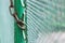 Close up chain locked on green fence gate