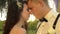 Close-up of a charming couple. Caucasian newlyweds closes their eyes with pleasure. Loving couple hugging each other at