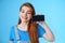 Close-up cheerful amazed cute redhead female look delighted, hold smartphone horizontal, show application, favorite