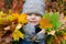close-up cheerful girl holding bouquets of colorful autumn leaves